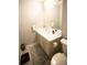 Neutrally-decorated half bathroom featuring modern vanity, fixtures, and decor at 102 Silver Fox Trl, Dallas, GA 30157
