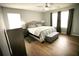 Stylish bedroom with a queen bed, wood-look flooring, and plenty of natural light at 102 Silver Fox Trl, Dallas, GA 30157