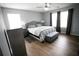 Stylish bedroom with a queen bed, wood-look flooring, and plenty of natural light at 102 Silver Fox Trl, Dallas, GA 30157