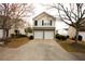 Two-story home featuring a two-car garage, neutral siding, a stone veneer and manicured landscaping at 102 Silver Fox Trl, Dallas, GA 30157