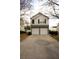 Two-story home featuring a two-car garage, neutral siding, a stone veneer and manicured landscaping at 102 Silver Fox Trl, Dallas, GA 30157