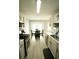 Galley kitchen with updated countertops, adjacent dining area, and stainless steel appliances at 102 Silver Fox Trl, Dallas, GA 30157