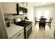 Kitchen features stainless appliances and an adjacent dining area at 102 Silver Fox Trl, Dallas, GA 30157