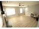 Bright living room featuring a ceiling fan, light gray walls, and light-colored laminate flooring at 102 Silver Fox Trl, Dallas, GA 30157