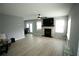 Spacious living room featuring a fireplace, light gray walls, and light-colored laminate flooring at 102 Silver Fox Trl, Dallas, GA 30157