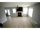 Bright living room featuring a fireplace, light gray walls, and light-colored laminate flooring at 102 Silver Fox Trl, Dallas, GA 30157