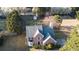 Aerial view of a well-maintained two-story home showcasing its roof, landscaping, and surrounding greenery at 3152 Parks Run, Loganville, GA 30052
