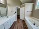 Bathroom with soaking tub and neutral color palette at 3152 Parks Run, Loganville, GA 30052