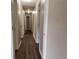 Long hallway featuring wood-look flooring and neutral paint at 3152 Parks Run, Loganville, GA 30052