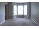 Cozy living room featuring large windows and neutral carpet at 3152 Parks Run, Loganville, GA 30052