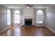 Bright living room featuring fireplace, hardwood floors, and large windows at 3152 Parks Run, Loganville, GA 30052
