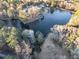 Lush greenery surrounds a peaceful lakefront community, captured from above at 4258 Rocky Ledge Way, Snellville, GA 30039