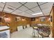 Basement game area with a deer head decoration, bar stools, and wood paneled walls at 4258 Rocky Ledge Way, Snellville, GA 30039