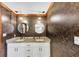 Bathroom showcasing double sinks, stylish lighting, and granite countertops at 4258 Rocky Ledge Way, Snellville, GA 30039
