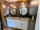 Bathroom showcasing double sinks, stylish lighting, and granite countertops at 4258 Rocky Ledge Way, Snellville, GA 30039