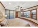 Bright bedroom with hardwood floors, bay windows, and a ceiling fan at 4258 Rocky Ledge Way, Snellville, GA 30039