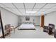 Simple bedroom with a double bed, minimalist decor, a rocking chair, and ample open space at 4258 Rocky Ledge Way, Snellville, GA 30039