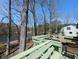 Inviting outdoor deck with seating area overlooking a tranquil lake view surrounded by lush greenery at 4258 Rocky Ledge Way, Snellville, GA 30039