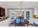 Bright dining area with views of the lake, an eat sign, and a chandelier at 4258 Rocky Ledge Way, Snellville, GA 30039