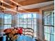 Charming dining area featuring a chandelier, windows with a view, and a floral centerpiece at 4258 Rocky Ledge Way, Snellville, GA 30039