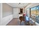 Elegant dining area with a chandelier, large windows offering views, and a modern design at 4258 Rocky Ledge Way, Snellville, GA 30039