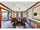Elegant dining room with a long wooden table, stylish chandelier, and beautiful wall decor at 4258 Rocky Ledge Way, Snellville, GA 30039