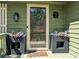 Close-up of the front door featuring a decorative wreath and potted flowers for added curb appeal at 4258 Rocky Ledge Way, Snellville, GA 30039