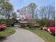 Charming single-story home with a well-manicured front yard and a long, winding driveway at 4258 Rocky Ledge Way, Snellville, GA 30039