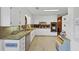 Spacious kitchen with white cabinetry, granite countertops, and stainless steel appliances at 4258 Rocky Ledge Way, Snellville, GA 30039