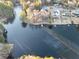 Aerial shot highlights the tranquil lake and homes nestled among mature trees at 4258 Rocky Ledge Way, Snellville, GA 30039