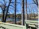 Scenic lake view with mature trees seen from wooden deck with green painted railing at 4258 Rocky Ledge Way, Snellville, GA 30039