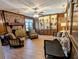 Cozy living room featuring a brick fireplace, wood paneling, and stylish furnishings at 4258 Rocky Ledge Way, Snellville, GA 30039