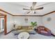 Relaxing living room with modern ceiling fan, comfortable seating, and stylish decor at 4258 Rocky Ledge Way, Snellville, GA 30039