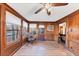 Bright sun room with wood paneled walls, laminate wood floors, and plenty of natural light at 4258 Rocky Ledge Way, Snellville, GA 30039