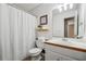 A simple bathroom with a shower and a neutral-colored wall at 656 New Hope Rd, Lawrenceville, GA 30046