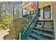 Inviting covered porch with wood stairs leading to the front door, adorned with an American flag and wreath at 656 New Hope Rd, Lawrenceville, GA 30046