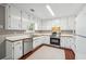 Bright kitchen featuring ample cabinet space, stainless steel appliances, and durable wood-look floors at 656 New Hope Rd, Lawrenceville, GA 30046