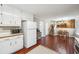 Spacious kitchen showcasing white appliances, ample cabinet space, and a view into the adjacent dining area at 656 New Hope Rd, Lawrenceville, GA 30046