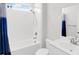 Clean bathroom with a shower-tub combination, blue shower curtain, and bright white fixtures at 100 Westchester Pass, Peachtree City, GA 30269