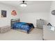 Themed bedroom featuring a bed with blue bedding, complemented by wall art and decor at 100 Westchester Pass, Peachtree City, GA 30269