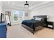 Spacious bedroom boasts large window, tray ceiling, and neutral decor at 100 Westchester Pass, Peachtree City, GA 30269