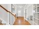Elegant hallway with hardwood floors, white trim, and a staircase leading to the upper level at 100 Westchester Pass, Peachtree City, GA 30269
