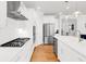 Bright kitchen featuring white cabinetry, a stainless steel gas range, and hardwood floors at 100 Westchester Pass, Peachtree City, GA 30269