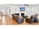 Inviting living room with a fireplace, hardwood floors, and cozy recliners at 100 Westchester Pass, Peachtree City, GA 30269