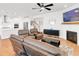 Open living room featuring fireplace, hardwood floors, and open floor plan at 100 Westchester Pass, Peachtree City, GA 30269
