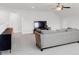 Spacious living room with a neutral-colored sofa, TV, and wall-mounted cabinets at 100 Westchester Pass, Peachtree City, GA 30269