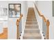 Carpeted staircase with modern black iron and wooden banister at 100 Westchester Pass, Peachtree City, GA 30269