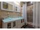 This bathroom features and sinks, tile walls, and a glass shower at 4985 Union St, Union City, GA 30291