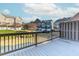 Spacious back deck overlooking the lush green yard with a view of the neighborhood buildings at 507 Grove Field Ct, Suwanee, GA 30024