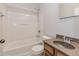 Functional bathroom featuring a vanity, toilet, and shower-tub combo with white tile surround at 507 Grove Field Ct, Suwanee, GA 30024
